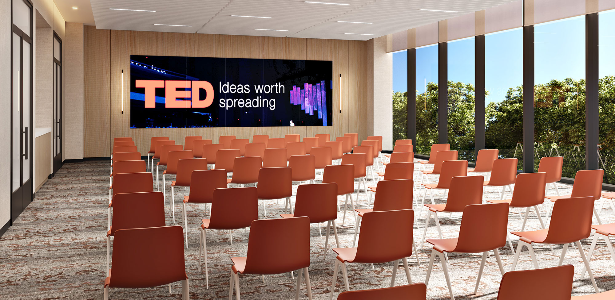 Empty conference room with rows of seats facing a screen at The Landing Burlingame